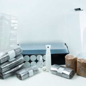 A mushroom growing kit with substrate bags, containers, bottles, and various supplies on a white background.