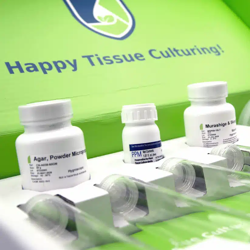 Plant Cell Tissue Culture Starter Kit 2 Three white Plant Cell Tissue Culture Starter Kit bottles are displayed in front of a green sign that says "Happy Tissue Culturing!.