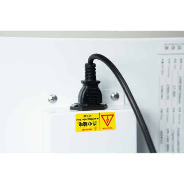 A Laminar Flow Hood H14 with prefilter (120x60x35cm) is plugged in with a black power lead to a white socket featuring an English and Chinese yellow electric shock warning label.