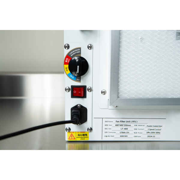 Close-up of the Laminar Flow Hood HEPA Airfilter H14 with prefilter 60x60x35cm control panel, showing warning labels, knobs, switches, and a connected power lead.
