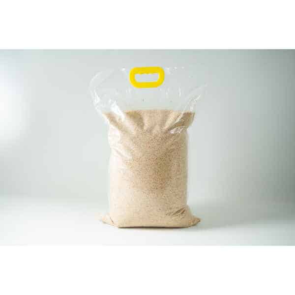 A clear plastic bag containing Certified Organic Biodynamic Rye berry grain, light brown granules, sealed with a yellow handle at the top.
