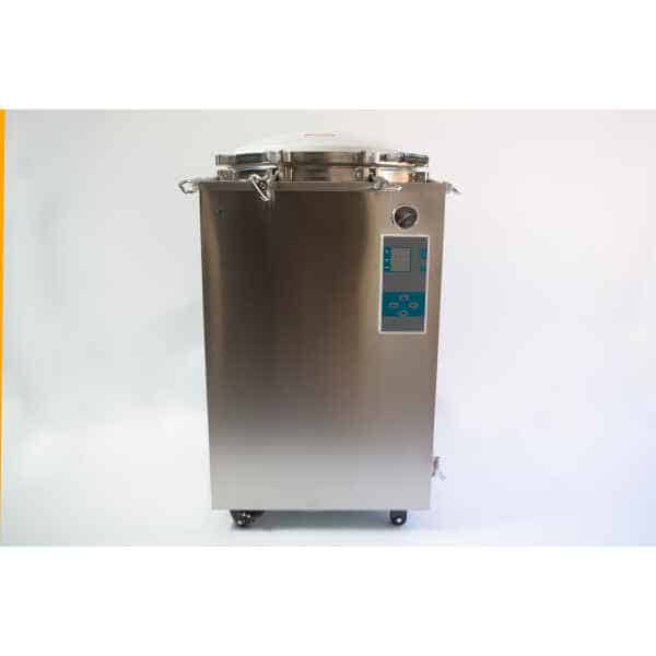 A stainless steel autoclave machine with a control panel and pressure gauge on the front.