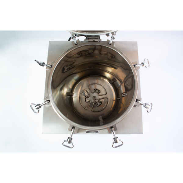 Top-down view of an open stainless steel industrial mixing or processing vessel with clamps around the edge.