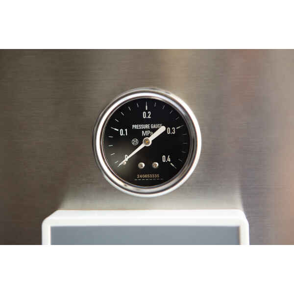 A close-up of a round black pressure gauge displaying measurements in MPa on a metallic surface.