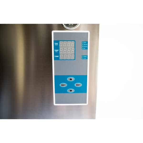 Close-up of a digital control panel with display screens and arrow buttons on a stainless steel surface.