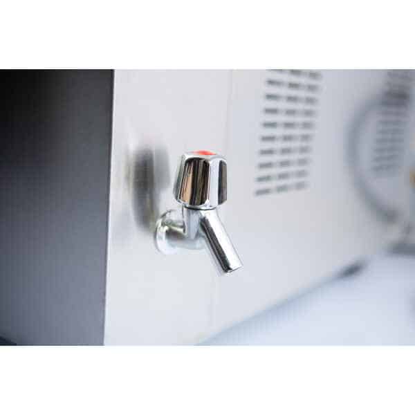 Close-up of a shiny metal water tap attached to a stainless steel appliance or dispenser.