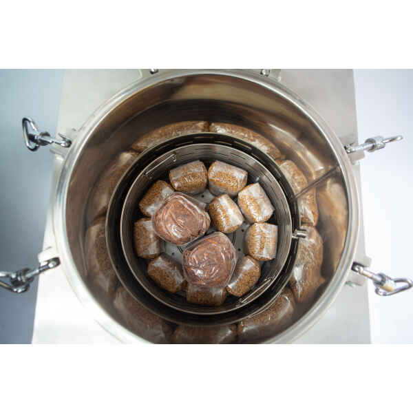 Top view of plastic-wrapped food bundles arranged inside a stainless steel container.