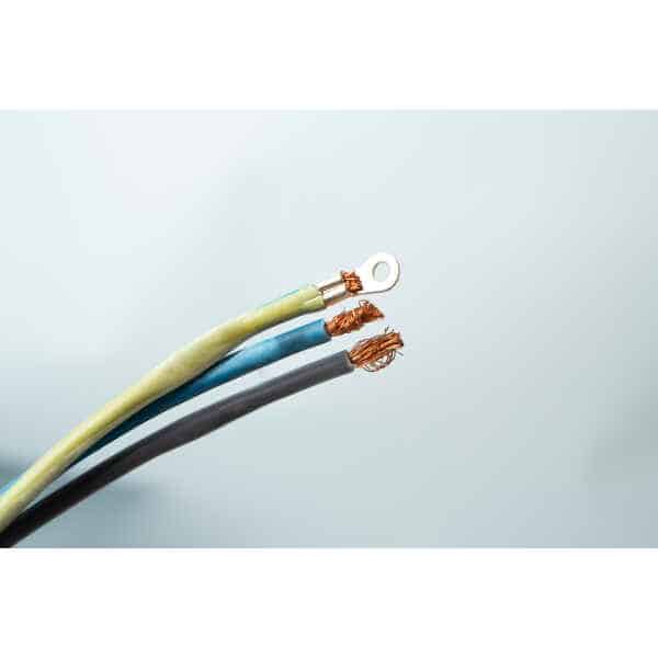 Three exposed electrical wires, one with a metal ring terminal, against a light grey background.