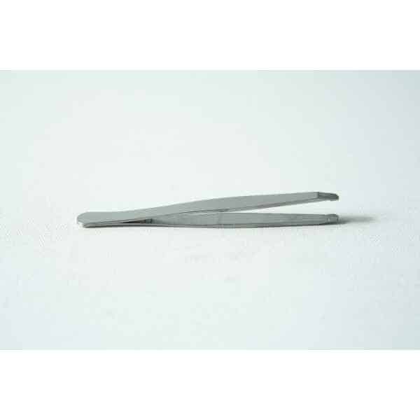 A pair of metal tweezers rests on a white surface, ideal for use with your slime mould kit - Physarum polycephalum.