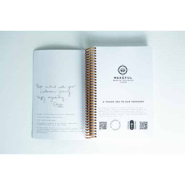 Wakeful Mushroom Cultivation Journal by Australian mycologist Caine Barlow, open to a handwritten note on the left page and a printed sponsor thanks on the right page.