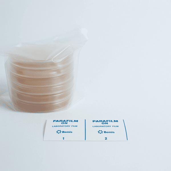 A stack of 5 MEA and 5 MEAG pre-poured 90mm agar plates, along with two Parafilm laboratory film labels, rest on a white surface.