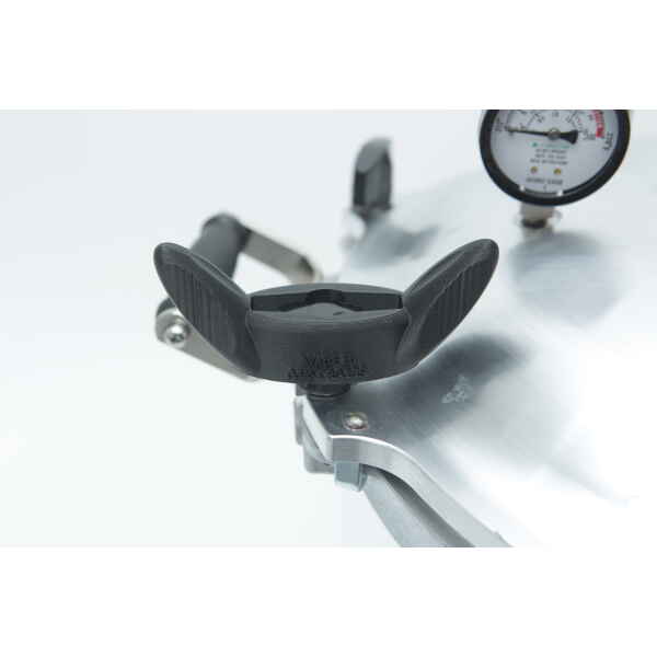 Close-up of an All American Tool pressure cooker lid featuring a black handle and pressure gauge, set against a white background.