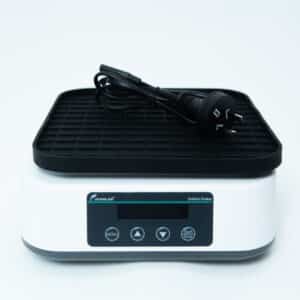 A digital laboratory orbital shaker with a power lead placed on top, on a white background.