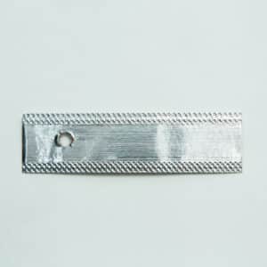 A rectangular metallic strip with a small round hole near one end, placed on a plain white background.