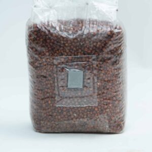 A sealed plastic bag filled with small brown seeds or grains on a plain white background.